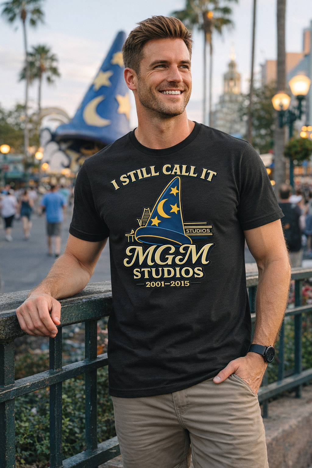 Man wearing a black t-shirt with MGM Studios logo in a theme park setting