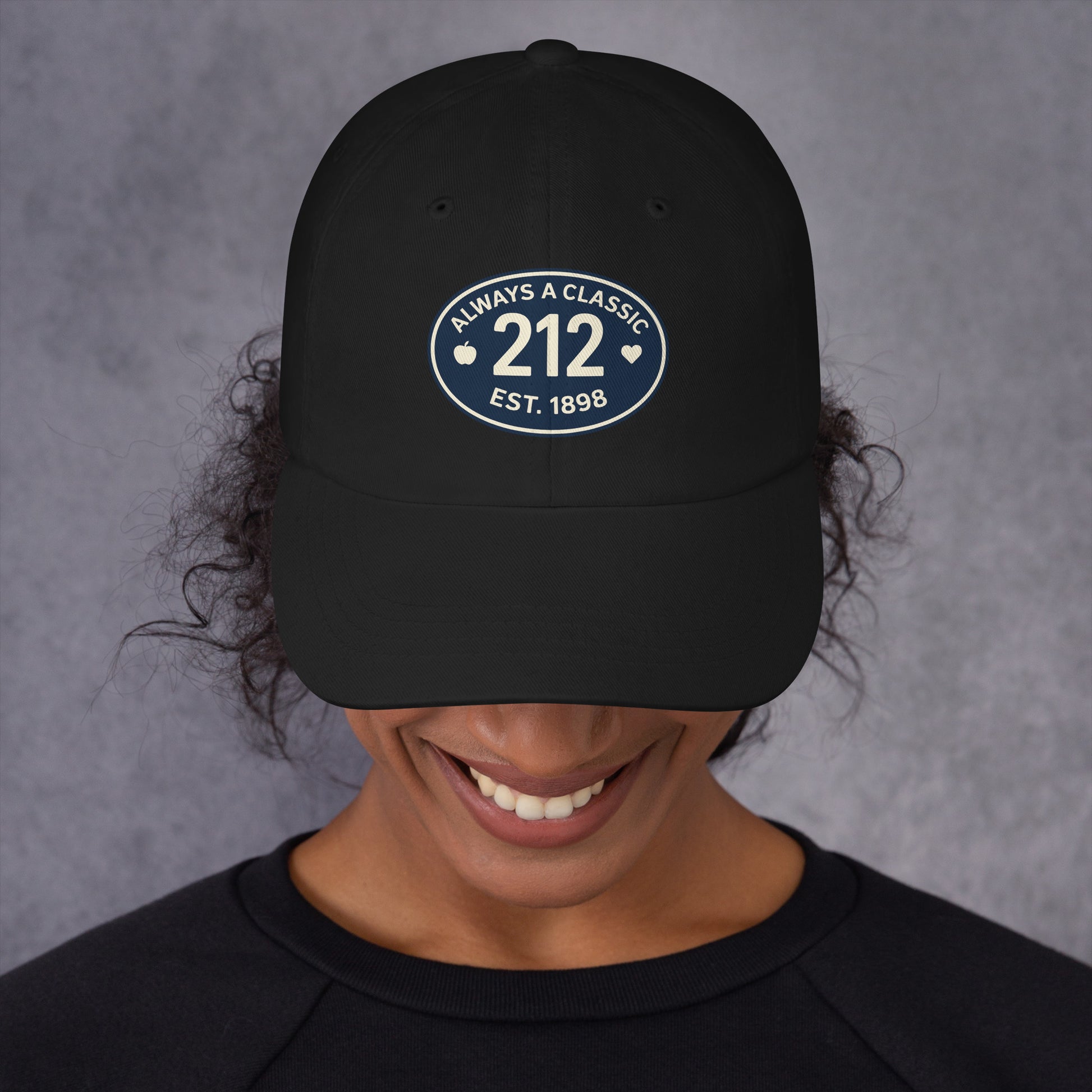 Black baseball hat with 212 embroidered on a smiling person.