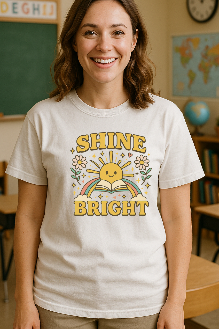 Woman wearing a t-shirt with 'Shine Bright' design in a classroom setting