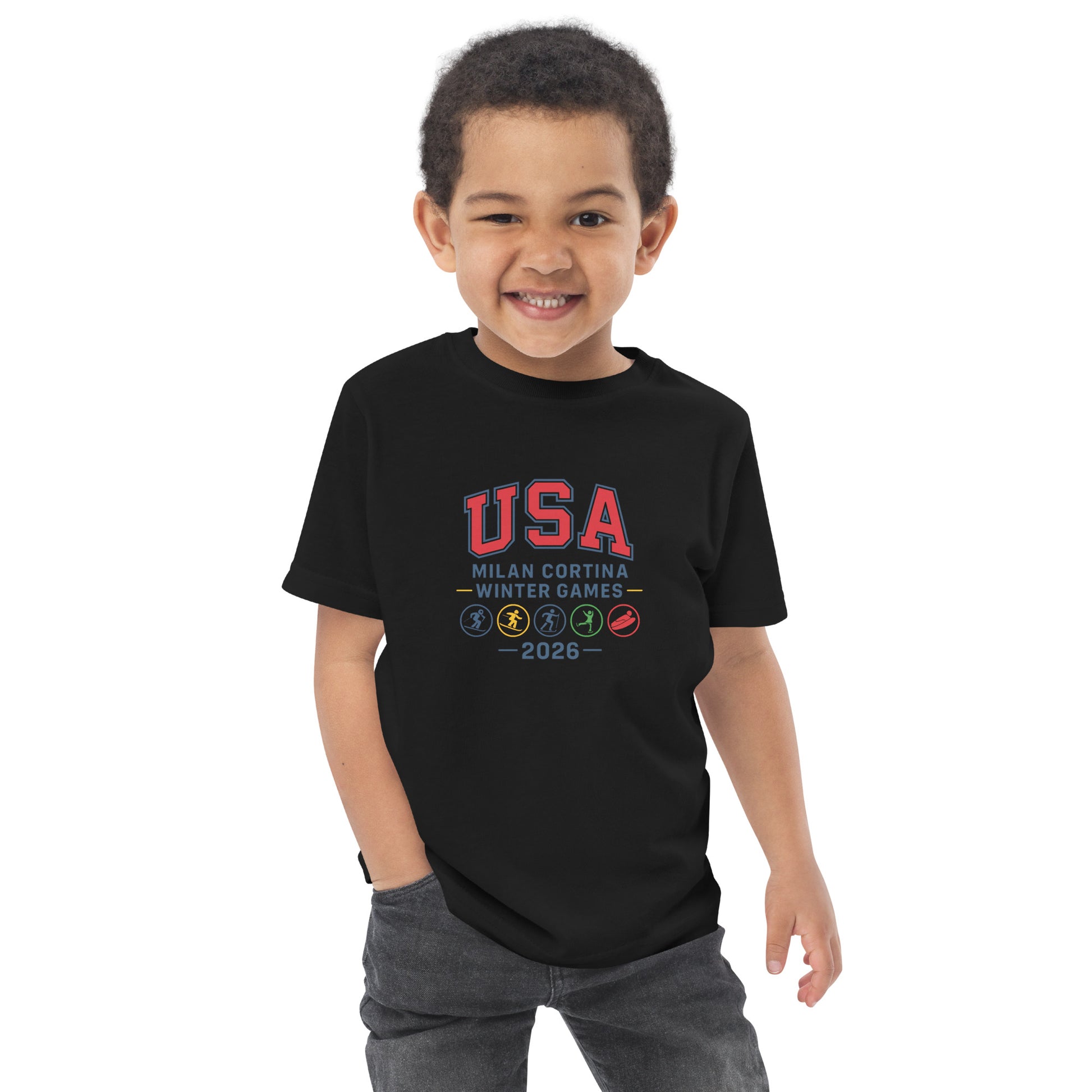 Child wearing a black t-shirt with 'USA Milan Cortina Winter Games 2026' text on a white background