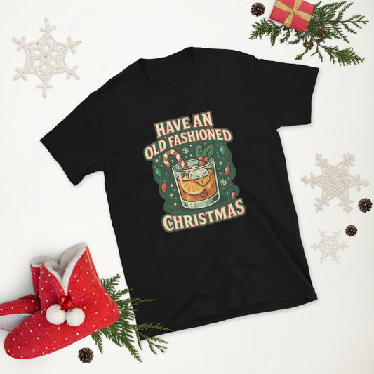 Black t-shirt with Christmas-themed graphic that says Have an Old Fashioned Christmas with a cocktail  on a white background with holiday decorations.