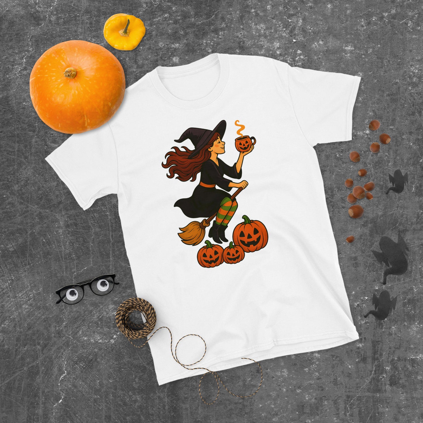 White t-shirt with a vintage style witch and hot drink on gray background with w pumpkin