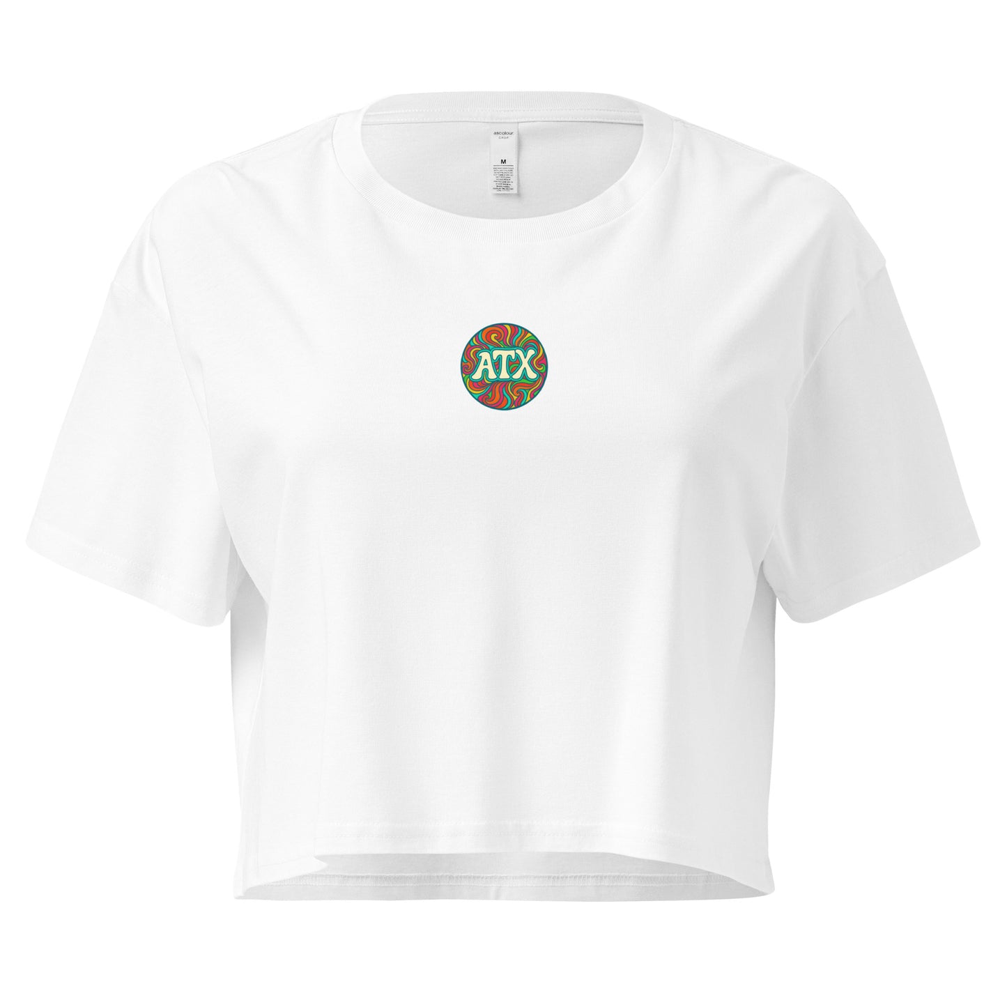 White women’s crop top with colorful retro circle graphic that says ATX, Austin Texas design, festival and summer fashion shirt.