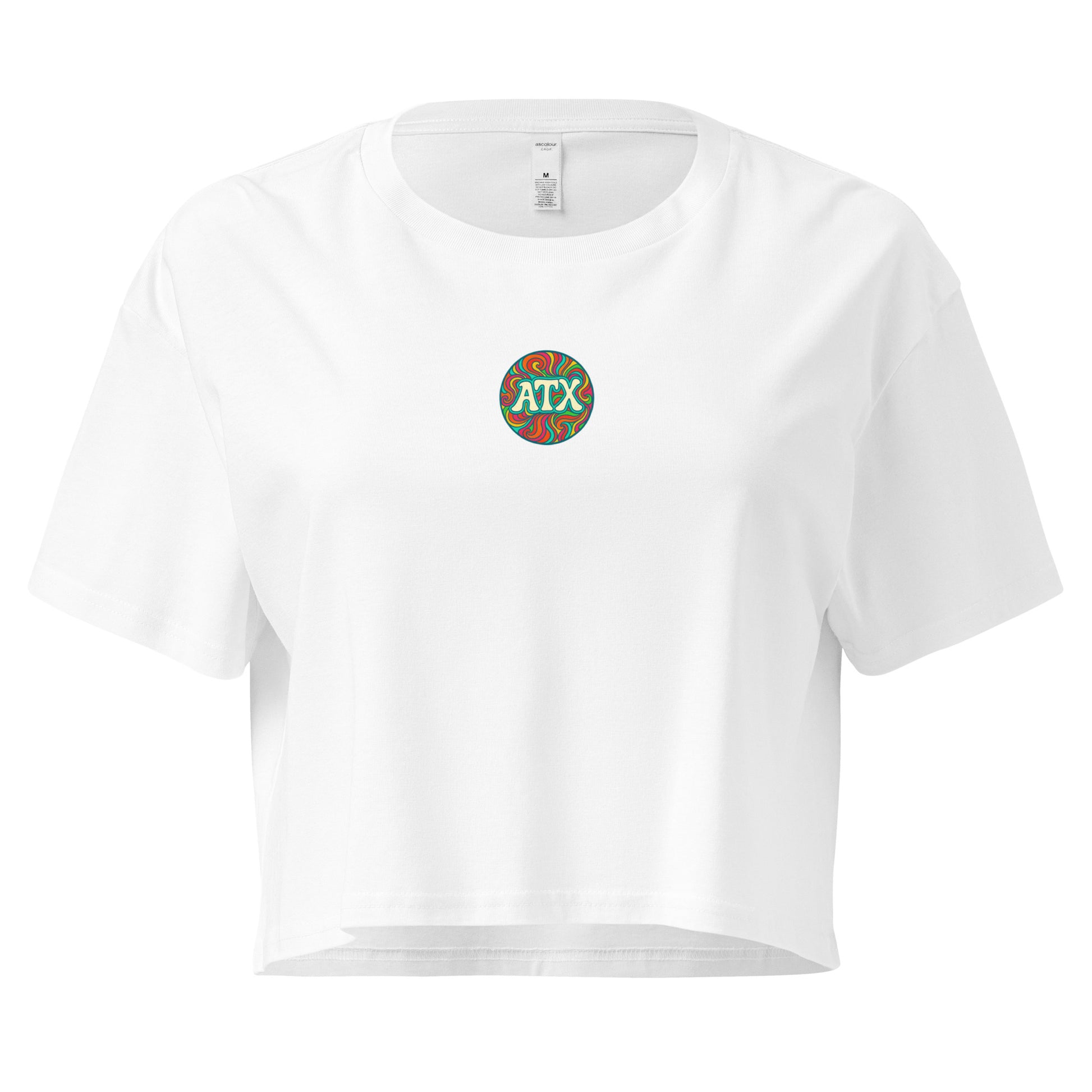 White women’s crop top with colorful retro circle graphic that says ATX, Austin Texas design, festival and summer fashion shirt.