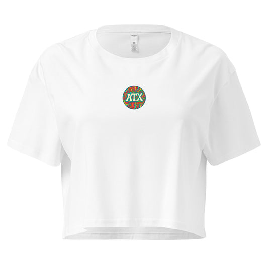 White women’s crop top with colorful retro circle graphic that says ATX, Austin Texas design, festival and summer fashion shirt.